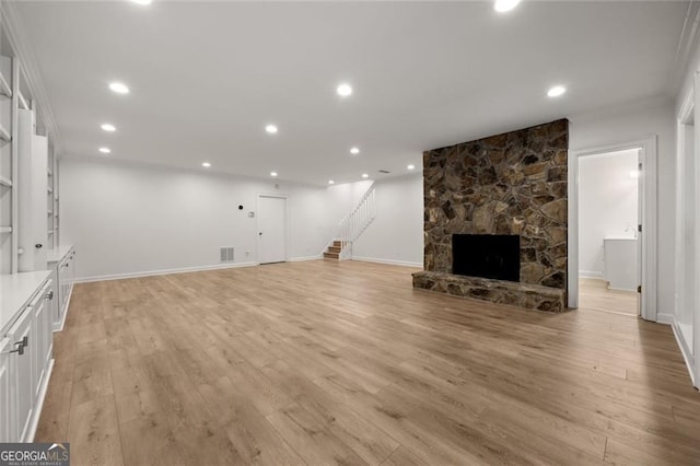 1260 Heards Ferry Rd, Sandy Springs, GA 30328 - unfurnished living room featuring stairway, light wood-style flooring, baseboards, a stone fireplace, and recessed lighting
