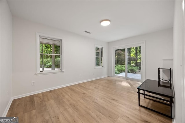 1260 Heards Ferry Rd, Sandy Springs, GA 30328 - unfurnished living room with plenty of natural light, light wood finished floors, and baseboards