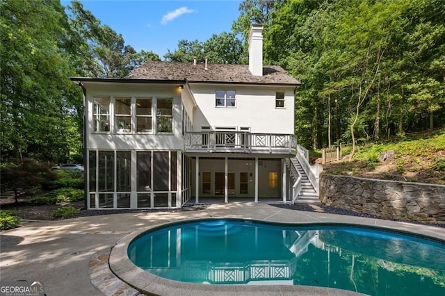 1260 Heards Ferry Rd, Sandy Springs, GA 30328 - back of property featuring stairs, a sunroom, a patio, an outdoor pool, and a deck