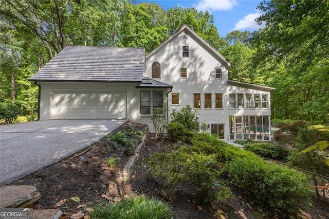 1260 Heards Ferry Rd, Sandy Springs, GA 30328 - view of front facade featuring stucco siding, driveway, and a garage