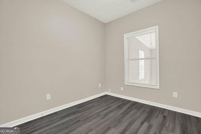 556 Poplar Bnd, Canton, GA 30114 - spare room featuring dark wood-type flooring and baseboards