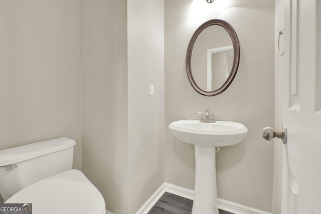 556 Poplar Bnd, Canton, GA 30114 - half bathroom featuring toilet, baseboards, and wood finished floors