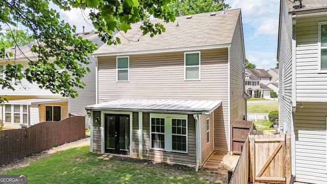 556 Poplar Bnd, Canton, GA 30114 - rear view of property with a shingled roof and a gate
