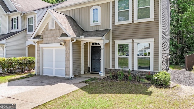 556 Poplar Bnd, Canton, GA 30114 - multi unit property featuring concrete driveway, board and batten siding, a garage, a front lawn, and roof with shingles