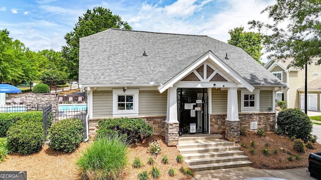 556 Poplar Bnd, Canton, GA 30114 - view of front of property featuring fence, roof with shingles, and stone siding