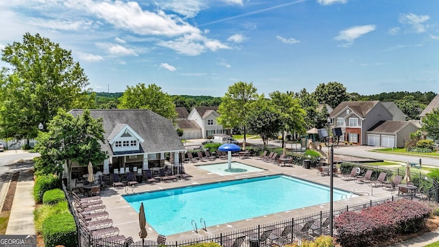 556 Poplar Bnd, Canton, GA 30114 - community pool with fence, a jacuzzi, a residential view, and a patio