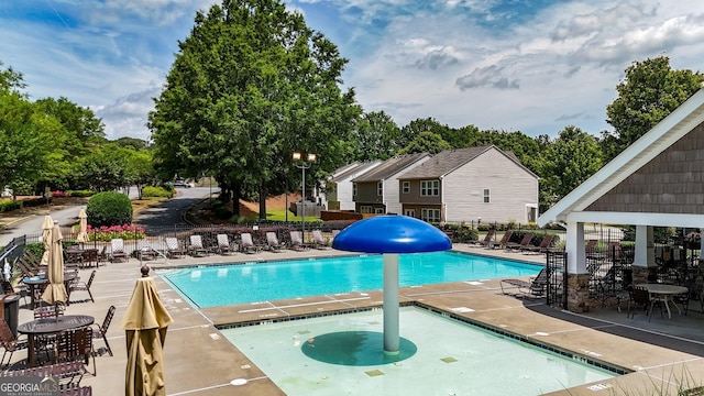 556 Poplar Bnd, Canton, GA 30114 - community pool with a hot tub, a patio, fence, and view of wooded area