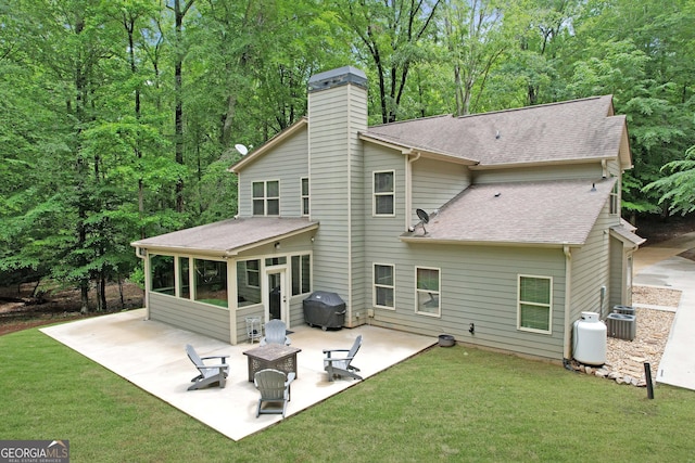 121 Hidden Springs Dr, Lagrange, GA 30240 - back of house with a sunroom, a patio area, roof with shingles, a chimney, and a yard
