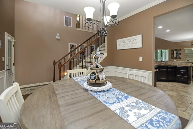121 Hidden Springs Dr, Lagrange, GA 30240 - dining area featuring a chandelier, stairs, wainscoting, and crown molding
