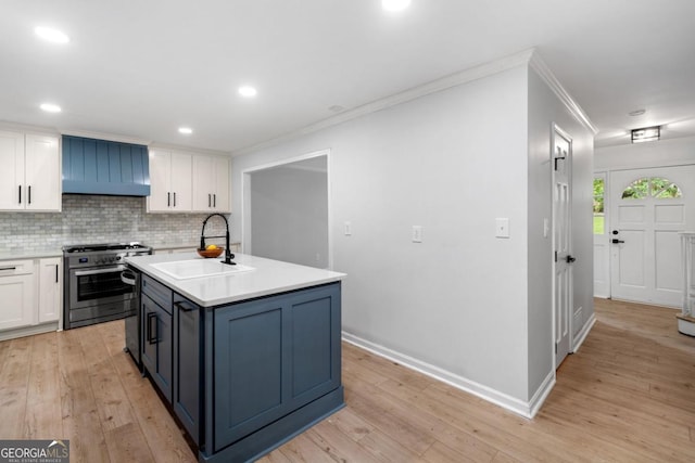 3078 Milford Chase SW, Marietta, GA 30008 - kitchen with stainless steel gas stove, a sink, white cabinetry, decorative backsplash, and crown molding