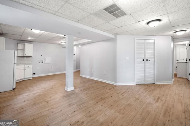 3078 Milford Chase SW, Marietta, GA 30008 - finished below grade area with freestanding refrigerator, a drop ceiling, baseboards, and light wood-type flooring