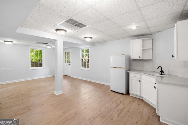 3078 Milford Chase SW, Marietta, GA 30008 - kitchen with freestanding refrigerator, a sink, a drop ceiling, white cabinets, and light countertops