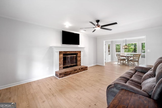 3078 Milford Chase SW, Marietta, GA 30008 - living area with ornamental molding, ceiling fan, wood finished floors, baseboards, and a fireplace