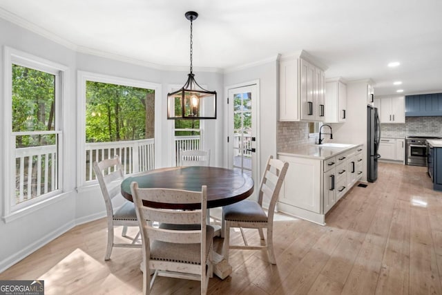 3078 Milford Chase SW, Marietta, GA 30008 - dining space with plenty of natural light, light wood-type flooring, crown molding, baseboards, and recessed lighting