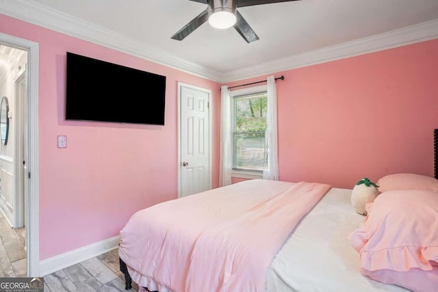 bedroom with crown molding, baseboards, and a ceiling fan