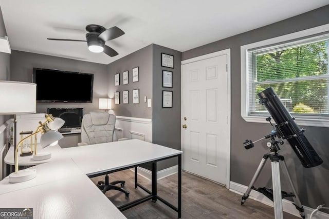 home office featuring a ceiling fan, wood finished floors, and baseboards