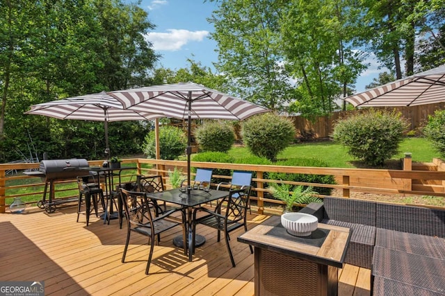 wooden terrace with outdoor dining space and area for grilling