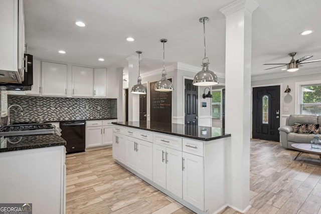 kitchen featuring dishwasher, crown molding, light wood-style flooring, backsplash, and ceiling fan