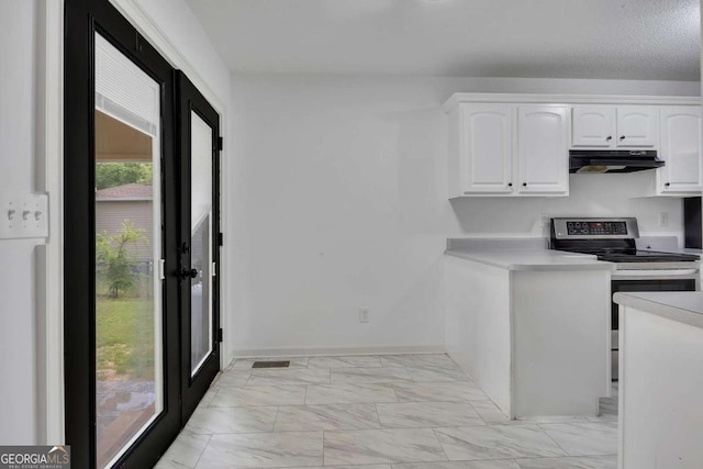 kitchen with under cabinet range hood, stainless steel electric range, light marble finish flooring, white cabinets, and light countertops