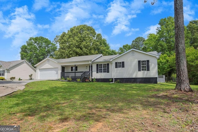 view of front facade with covered porch, a garage, a front yard, and concrete driveway