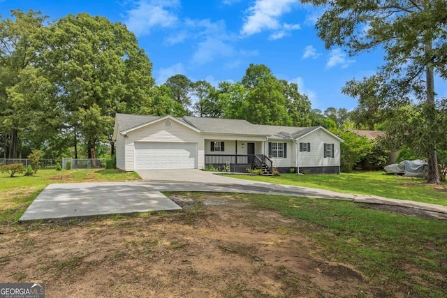 ranch-style house featuring an attached garage and covered porch