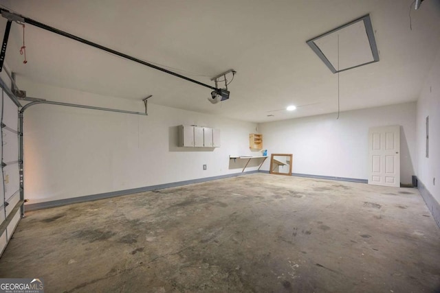 garage with recessed lighting, a garage door opener, and baseboards
