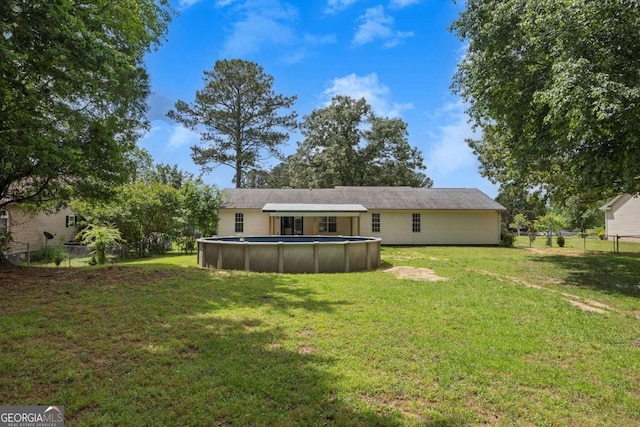 back of property featuring an outdoor pool