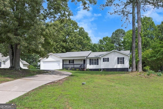 view of front of house with a front yard, an attached garage, and concrete driveway
