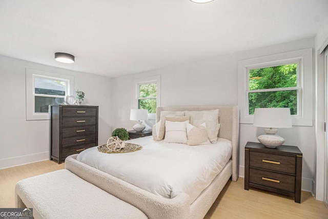 bedroom featuring light wood-style flooring and baseboards