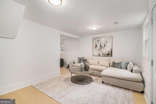 living room with light wood-type flooring and baseboards