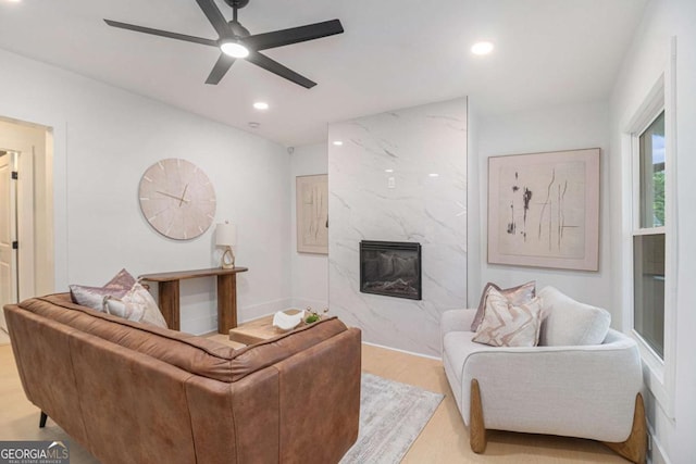 living room with a fireplace, a ceiling fan, and recessed lighting