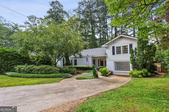 split level home with a front yard and concrete driveway