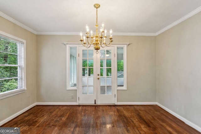 unfurnished dining area with wood-type flooring, a chandelier, french doors, healthy amount of natural light, and crown molding