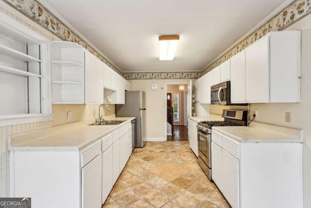 88 Karland Dr NW, Atlanta, GA 30305 - kitchen featuring stainless steel appliances, a sink, light countertops, white cabinets, and ornamental molding