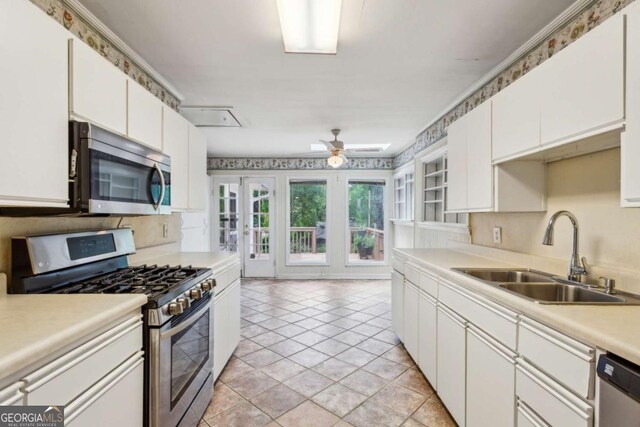 88 Karland Dr NW, Atlanta, GA 30305 - kitchen with stainless steel appliances, a sink, decorative backsplash, and white cabinetry