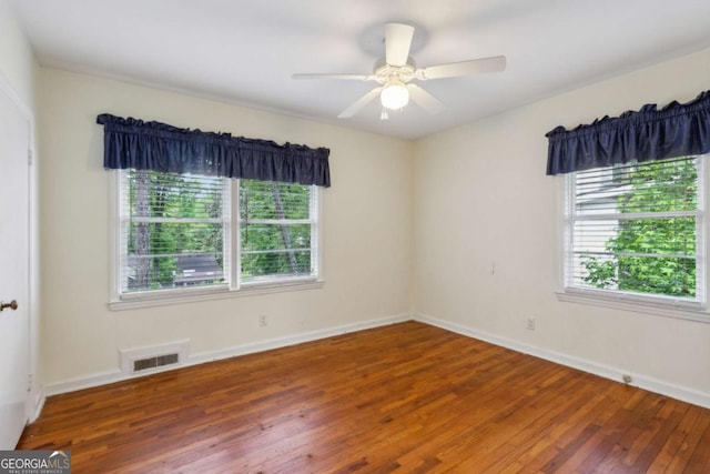 unfurnished room featuring hardwood / wood-style flooring, baseboards, and a ceiling fan