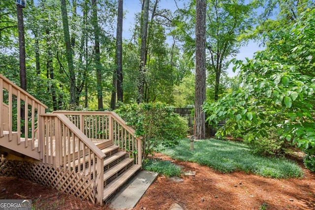 wooden terrace featuring stairs and fence