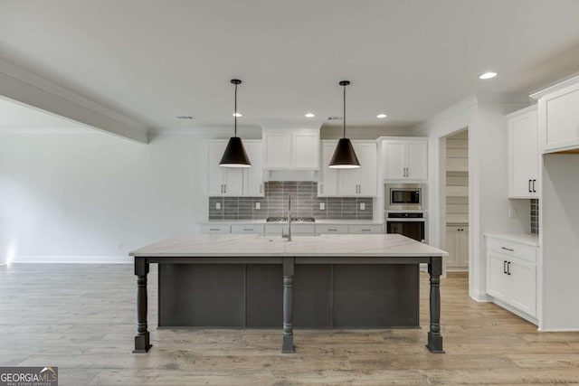 1241 Riverhill Dr, Bishop, GA 30621 - kitchen featuring appliances with stainless steel finishes, backsplash, a breakfast bar, white cabinetry, and crown molding