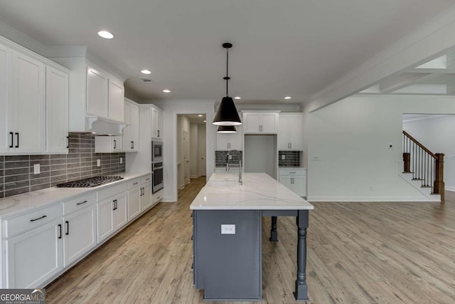 1241 Riverhill Dr, Bishop, GA 30621 - kitchen featuring a sink, stainless steel appliances, tasteful backsplash, white cabinets, and light wood finished floors