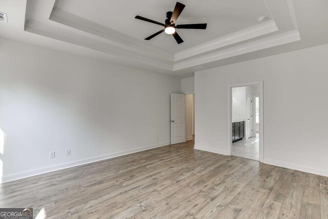 1241 Riverhill Dr, Bishop, GA 30621 - unfurnished bedroom featuring a raised ceiling, wood finished floors, ornamental molding, ensuite bathroom, and baseboards
