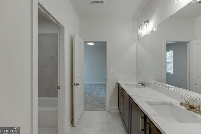 1241 Riverhill Dr, Bishop, GA 30621 - bathroom featuring double vanity, tile patterned flooring, baseboards, and a tub to relax in