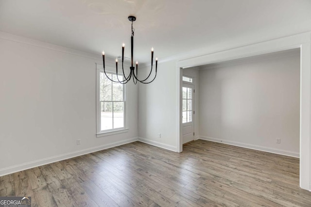 1241 Riverhill Dr, Bishop, GA 30621 - unfurnished dining area with a chandelier, wood finished floors, and baseboards