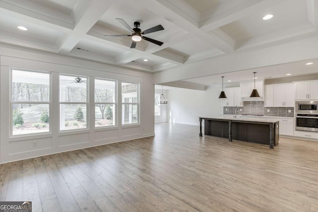 1241 Riverhill Dr, Bishop, GA 30621 - living room with a ceiling fan, healthy amount of natural light, light wood-style floors, beamed ceiling, and coffered ceiling