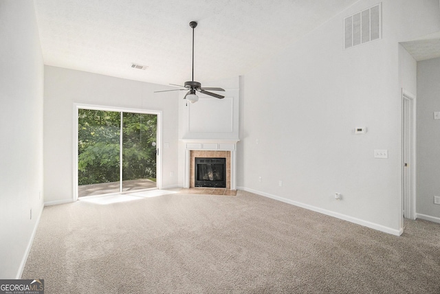 712 Brambling Way, Stockbridge, GA 30281 - unfurnished living room featuring carpet, ceiling fan, and a tiled fireplace