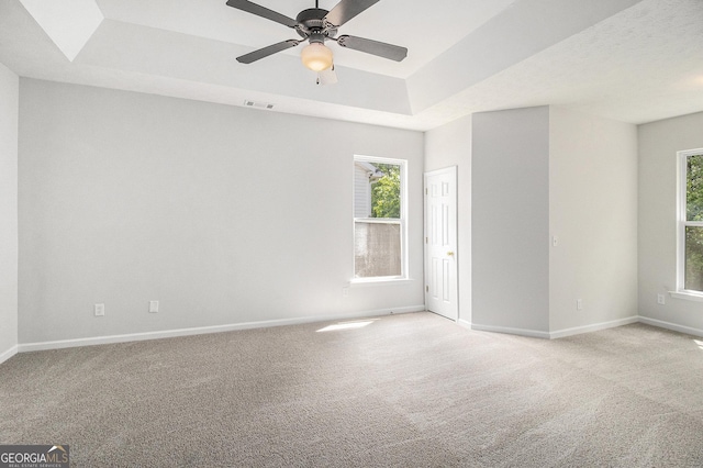 712 Brambling Way, Stockbridge, GA 30281 - empty room featuring a tray ceiling, carpet, and plenty of natural light