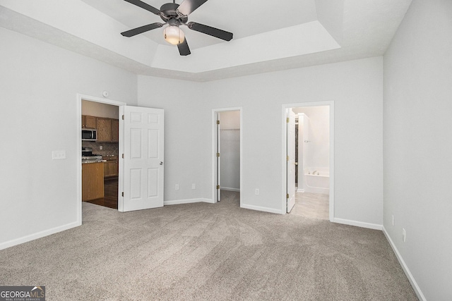 712 Brambling Way, Stockbridge, GA 30281 - unfurnished bedroom featuring a spacious closet, carpet floors, a closet, ensuite bathroom, and a ceiling fan