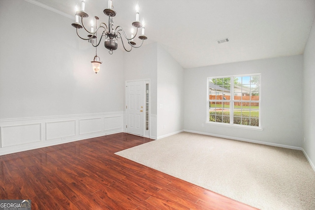 712 Brambling Way, Stockbridge, GA 30281 - unfurnished room with a chandelier, wood finished floors, and vaulted ceiling
