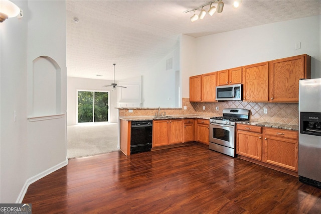 712 Brambling Way, Stockbridge, GA 30281 - kitchen featuring appliances with stainless steel finishes, vaulted ceiling, dark wood-style flooring, backsplash, and brown cabinets