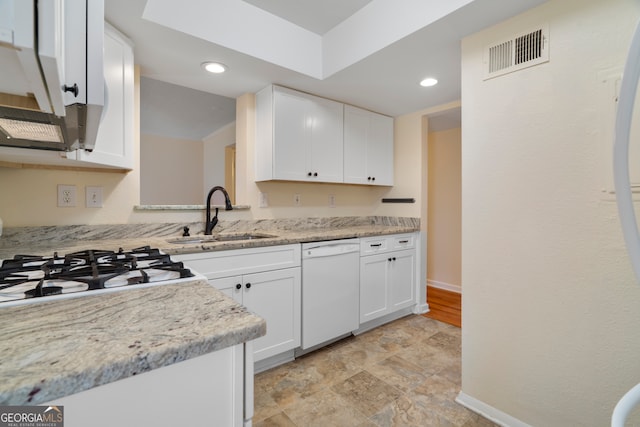 3301 Henderson Mill Rd Unit J1, Atlanta, GA 30341 - kitchen featuring a sink, white dishwasher, white cabinetry, baseboards, and recessed lighting