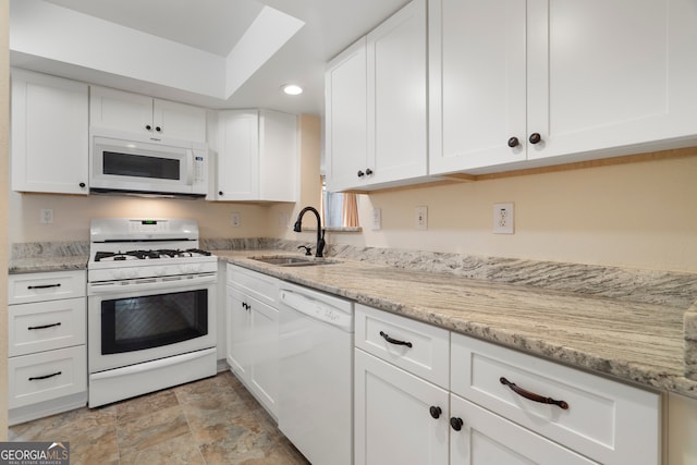 3301 Henderson Mill Rd Unit J1, Atlanta, GA 30341 - kitchen featuring white appliances, a sink, white cabinets, recessed lighting, and stone finish floors